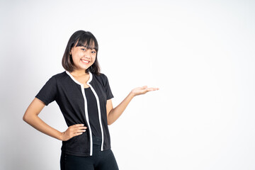 Young asian woman with hand gesture presenting something on isolated background