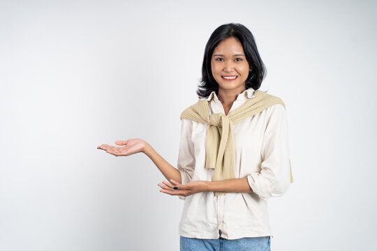 Asian girl with hand gesture presenting something on isolated background
