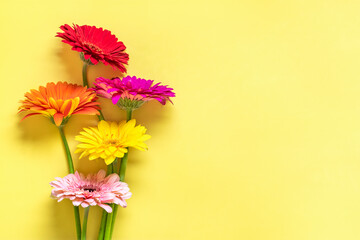 Bouquet of gerberas on yellow background Top view Flat lay Holiday greeting card Happy moter's day, 8 March, Valentine's day, Easter concept Copy space Mock up