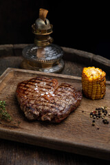 grilled meat steak on a wooden board with spices in a premium restaurant
