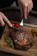 grilled meat steak on a wooden board with spices in a premium restaurant
