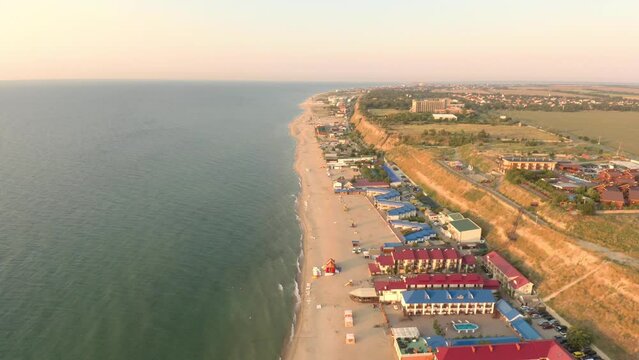 Bird's eye view of hotels on a sandy beach of the Black Sea reflecting sunrise in Zatoka, Ukraine