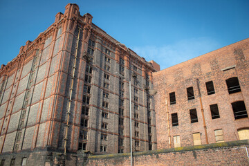 Low angle view of a Former dockland warehouse being redeveloped, Liverpool - obrazy, fototapety, plakaty