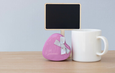 White ceramic mug, Pink heart gift box and wooden tag are placed on the table, Present for Fathers day, Mother's day, Valentine's day.