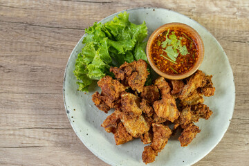 Fried pork with fish sauce and spicy jaew sauce