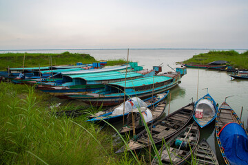 Fototapeta na wymiar Beautiful Landscape View of Some wooden fishing boats on the green bank of the Padma river in Bangladesh