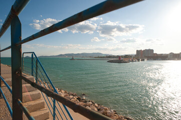 Panoramic view of the entrance to the port of Benicarló. Concrete wall and breakwater of the port. sunset in the harbor