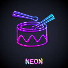 Glowing neon line Drum with drum sticks icon isolated on black background. Music sign. Musical instrument symbol. Vector