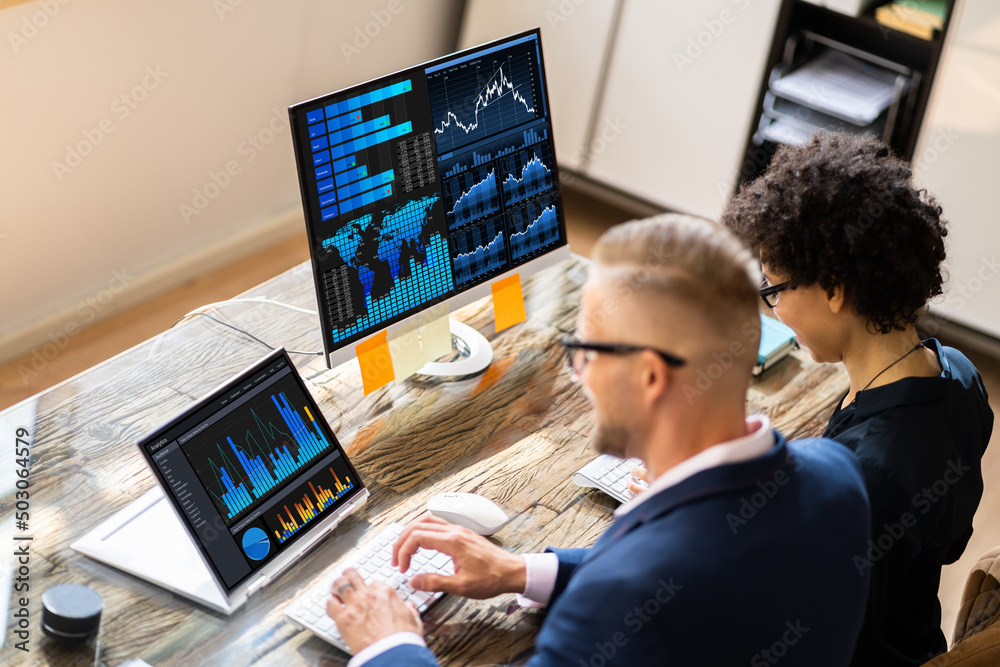 Poster Two Stock Market Brokers Discussing Graphs On Computer