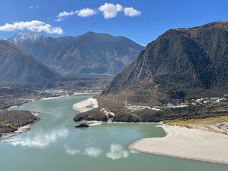 Beautiful view of the Indus river surrounded by mountains in sunny weather