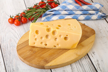 Maasdam cheese piece over board