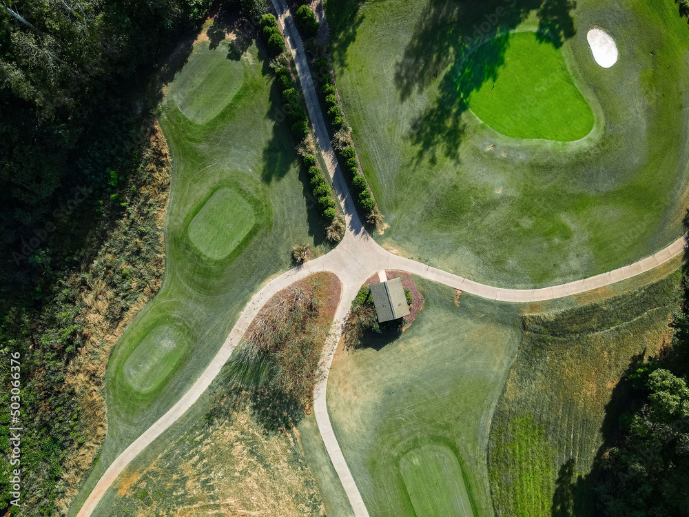 Sticker View of trees and lawns and a golf villa in a golf course on a sunny day