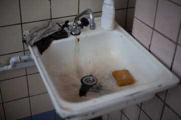 Sink in dining room. Kitchen details. Place to wash dishes. Faucet is turned off.