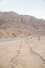 desert path with mountains and valleys dry out of focus with grain