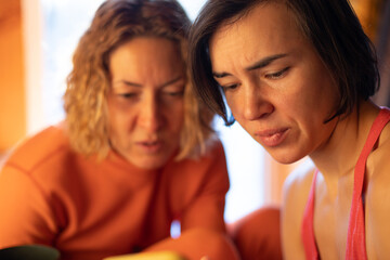 woman showing her friend a picture on a smartphone