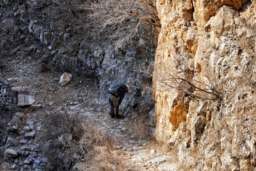 Aerial back view of a mountain climber taking a rest in Beijing, China