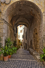 Fototapeta premium Narrow street among the old houses of Giuliano di Roma, a village in the Lazio region of Italy