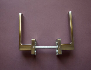 Set of modern metal door handles in silver color. View from above.