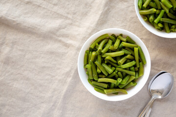 Steamed Green Beans in a White Bowl, top view. Overhead, from above, flat lay. Space for text.