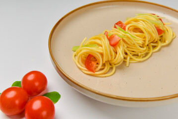 Italian pasta on a plate closeup with tomatoes