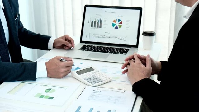 Business meeting, Businessman is summarizing financial graphs and analyzing market trends from a laptop to develop a company's revenue, Brainstorming or Discussing concept.