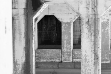 Old concrete arches worn down by lots of use in black and white monochrome.