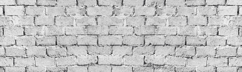 Old rough light gray exterior brick wall wide texture. Aged shabby masonry. Abstract grunge brickwork large long background