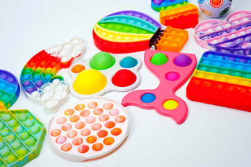 Fototapeta na wymiar Rainbow bubble toys in different shapes to relieve stress.