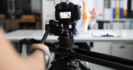 Videographer filming doctor on professional camera closeup 4k movie slow motion - Powered by Adobe