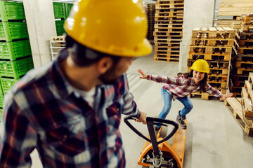Two worker having fun time at work with forklift.