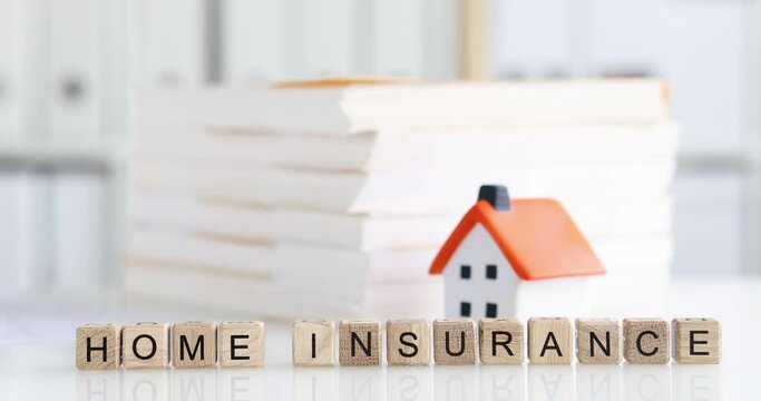 Home insurance documents lying near toy house 4k movie slow motion