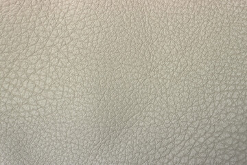 Photo of the texture of white genuine leather. White background made of leather fabric.The texture of light leather for production .
