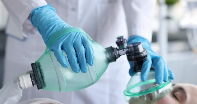 Doctor providing emergency care to patient using ambu bag closeup 4k movie slow motion