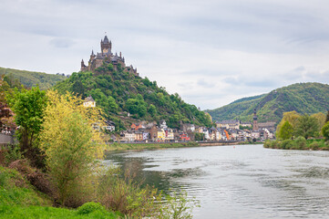 Picturesque view of a castle on a hill near the historic town of Cochem along the river Moselle in Germany