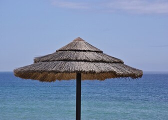 Tropical bast sun umbrellas on the Algarve coast - Portugal 
