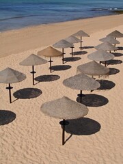 Tropical bast sun umbrellas on the Algarve coast - Portugal 