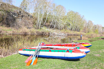 catamaran rafting on a stormy river. catamarans and paddles on the shore. 