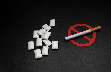 nicotine replacement gum next to a cigarette with the forbidden sign, concept of quitting smoking