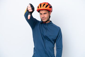 Young cyclist caucasian man isolated on white background showing thumb down with negative expression