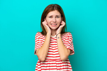 Young English woman isolated on blue background frustrated and covering ears