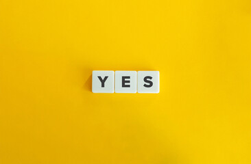 Yes Word on Letter Tiles on Yellow Background. Minimal Aesthetics.