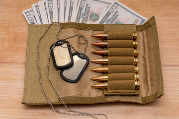 Army identification medallions on American dollar bills, bandolier with live ammunition. Concept:...
