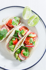 Delicious and homemade tacos made of tomatoes, avocado and hebrs.