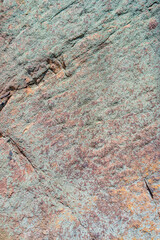 Cover page with Pattern of granite stone wall covered with moss and lichen, as a background, closeup, details.