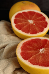 Fototapeta na wymiar sliced ripe grapefruit on a light cloth