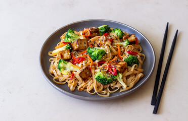 Udon noodles with tofu, broccoli, carrots, pepper and sesame. Healthy eating. Vegetarian food....