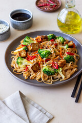 Udon noodles with tofu, broccoli, carrots, pepper and sesame. Healthy eating. Vegetarian food. Asian food.