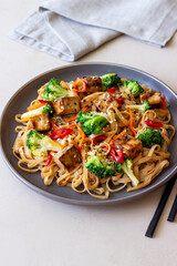 Udon noodles with tofu, broccoli, carrots, pepper and sesame. Healthy eating. Vegetarian food. Asian food.