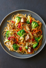Udon noodles with tofu, broccoli, carrots, pepper and sesame. Healthy eating. Vegetarian food. Asian food.