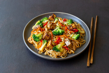 Udon noodles with tofu, broccoli, carrots, pepper and sesame. Healthy eating. Vegetarian food. Asian food.